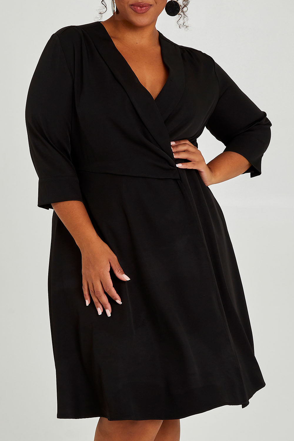 Model Alexis wearing size 16 of The Contemporary Lapel Dress in colour Black (Black), from the front, cropped image