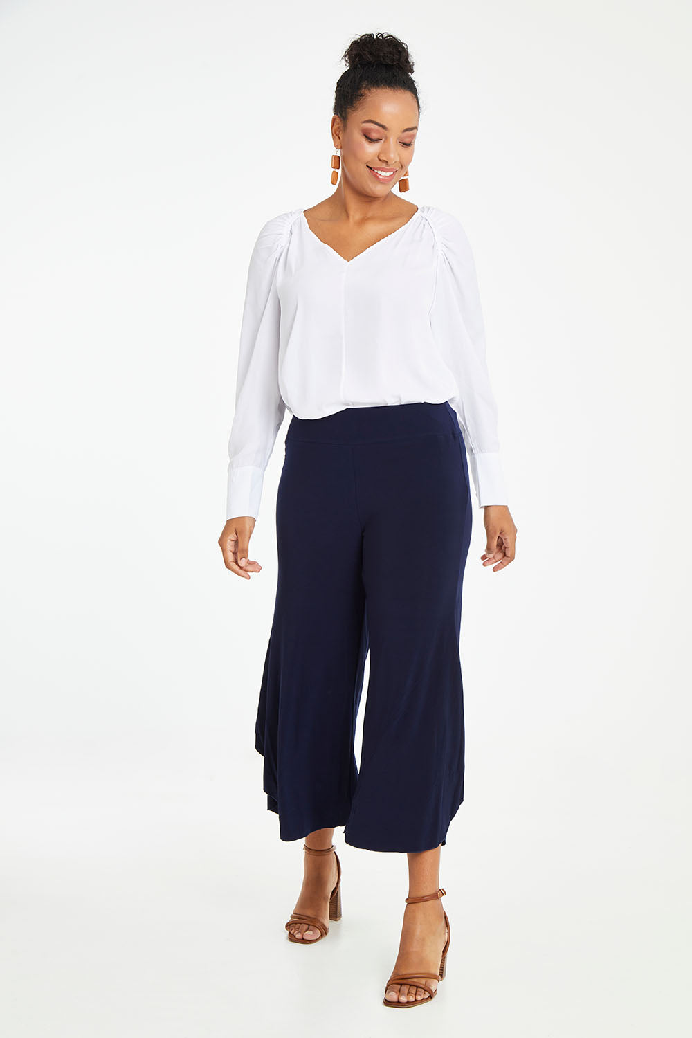 Model Noli wearing size 14 of The Pleated Raglan Sleeve Blouse in colour White (White), from the front, showing the whole outfit