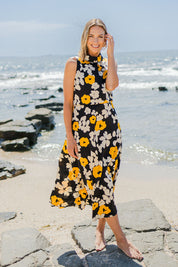 Model Riina wearing size 10 of The Printed Roll Neck Dress in colour Flower (Black), from the front, showing the whole outfit