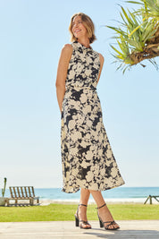 Model Riina wearing size 10 of The Printed Roll Neck Dress in colour Blkblossom (Black), from the front, showing the whole outfit