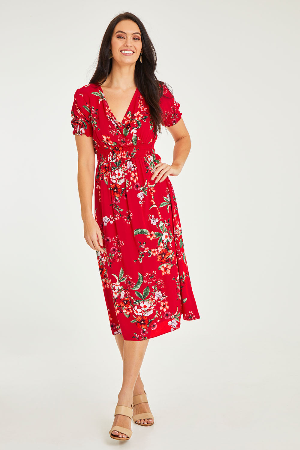 Model Stacey wearing size 10 of The Printed Smock Waist Dress in colour Hibiscus (Red), from the front, showing the whole outfit