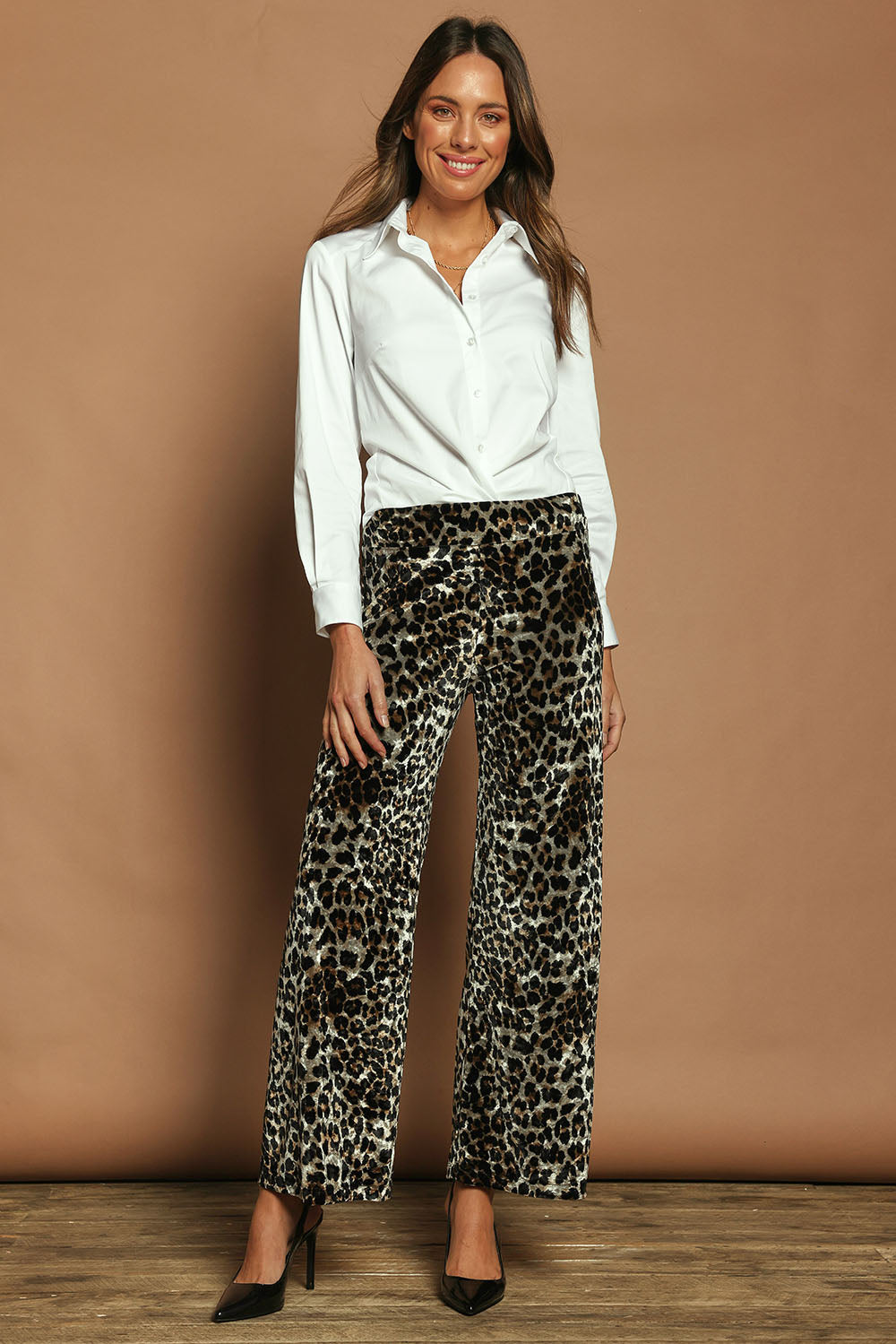 Model Madeline wearing size 10 of The Printed Velvet Pull On Pant in colour Leopard (Black), from the front, showing the whole outfit