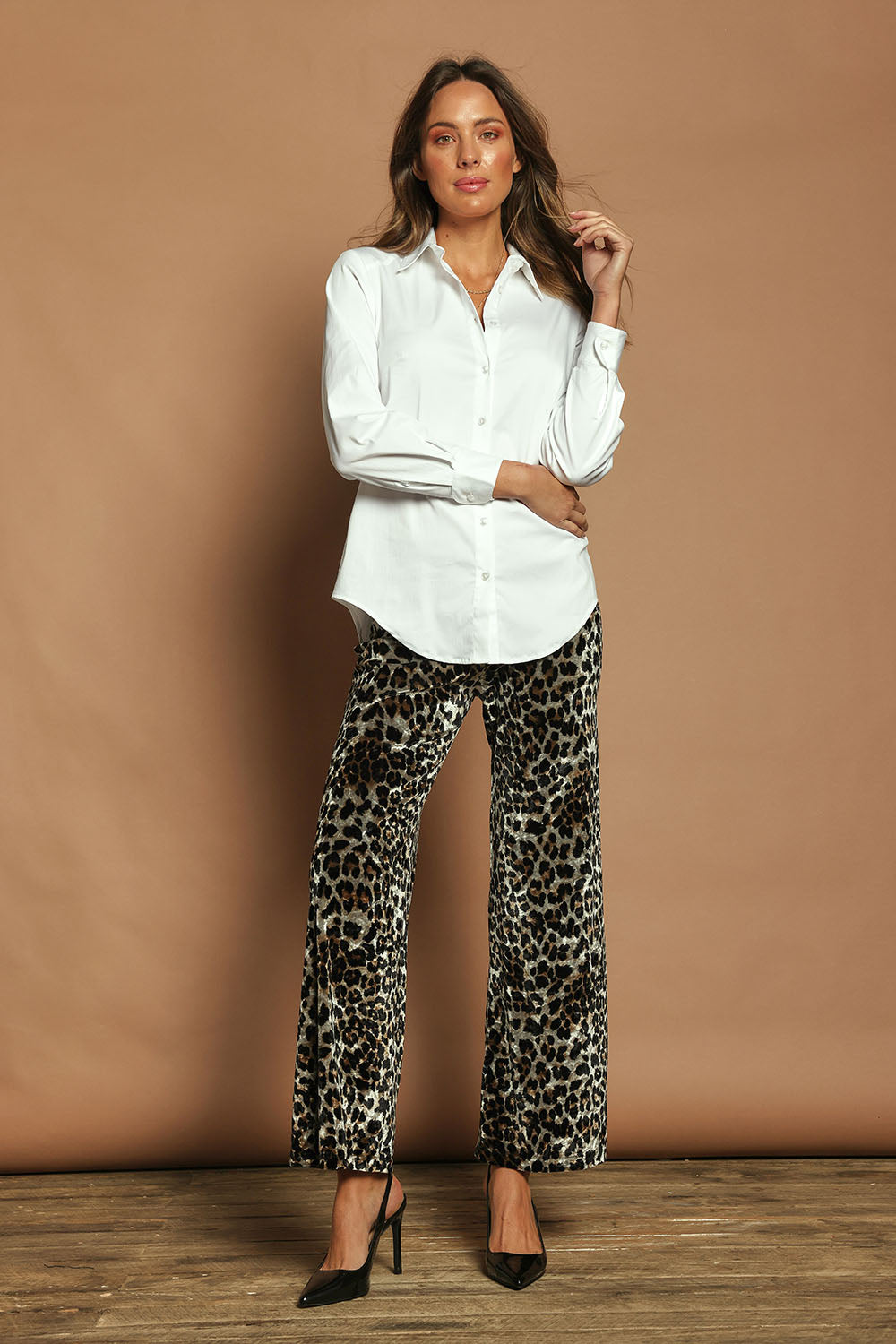 Model Madeline wearing size 10 of The Printed Velvet Pull On Pant in colour Leopard (Black), from the front, showing the whole outfit