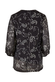 Product shot of The Lined V Neck Blouse in colour Vines (Black), from the back