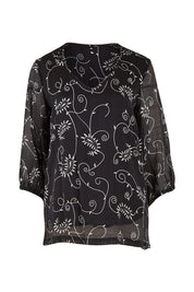 Product shot of The Lined V Neck Blouse in colour Vines (Black), from the front