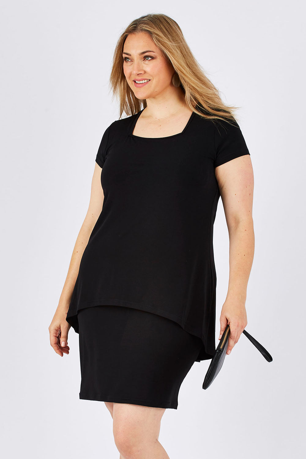 Model Ljubenka wearing size 18 of The Short Sleeve Rita Dress in colour Black (Black), from the front, cropped image