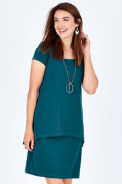 Model Rebecca wearing size 10 of The Short Sleeve Rita Dress in colour DarkTeal (Green), from the front, cropped image