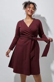 Model Alexis wearing size 16 of The Fit And Flare Ponte Dress in colour Burgundy (Red), from the front, showing the whole outfit