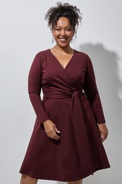 Model Alexis wearing size 16 of The Fit And Flare Ponte Dress in colour Burgundy (Red), from the front, showing the whole outfit