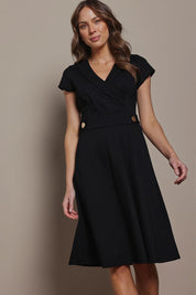 Model Madeline wearing size 10 of The Cap Sleeve Ponte Lapel Dress in colour Black (Black), from the front, cropped image