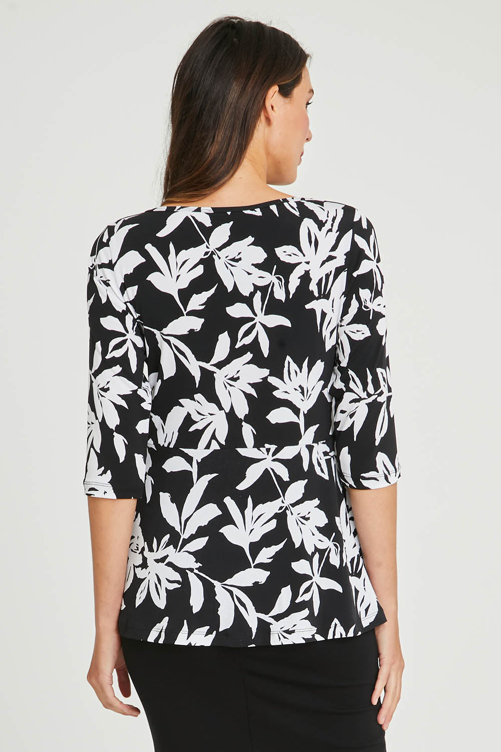 Model Madeline wearing size 10 of The Tie Detail Top in colour Lily (Black), from the back