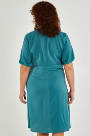 Model Maddy wearing size 16 of The Buckle Detail Faux Wrap Dress in colour Lagoon (Green), from the back