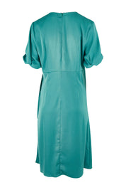 Product shot of The Buckle Detail Faux Wrap Dress in colour Lagoon (Green), from the back
