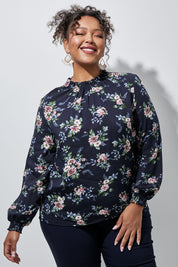 Model Alexis wearing size 16 of The Smocking Detail Printed Top in colour Flower (Blue), from the front, showing the whole outfit