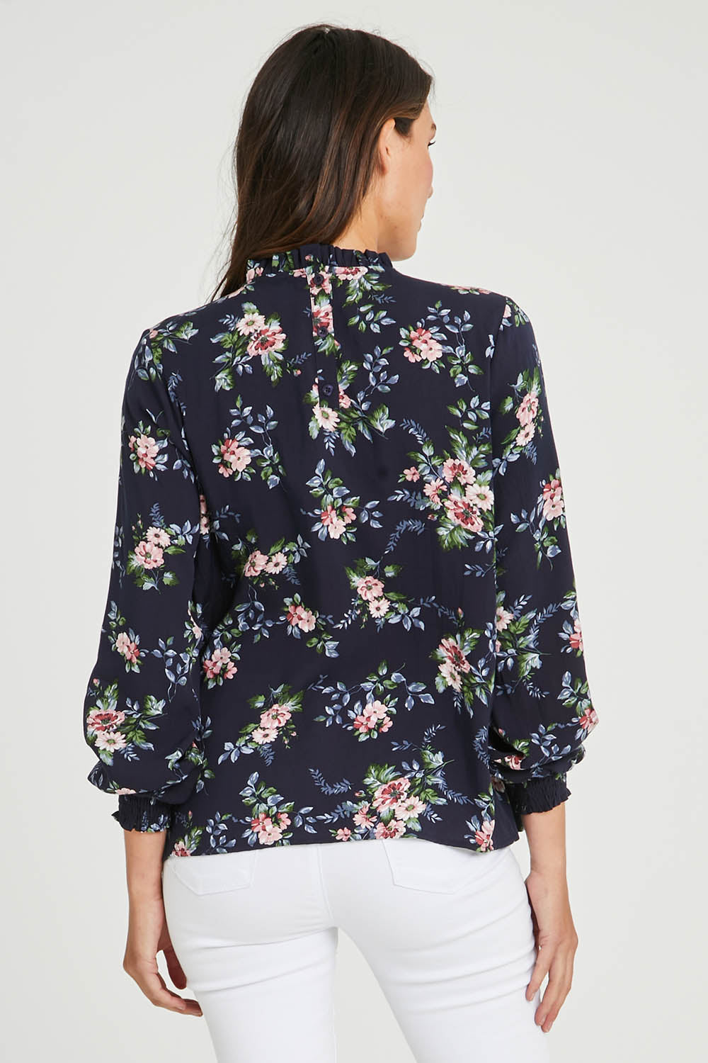 Model Madeline wearing size 10 of The Smocking Detail Printed Top in colour Flower (Blue), from the back