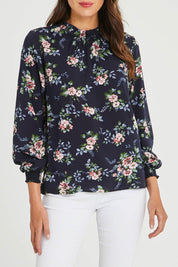 Model Madeline wearing size 10 of The Smocking Detail Printed Top in colour Flower (Blue), from the front, cropped image