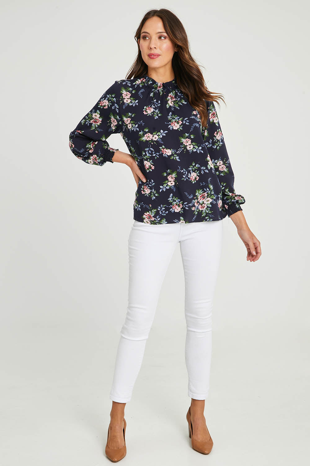 Model Madeline wearing size 10 of The Smocking Detail Printed Top in colour Flower (Blue), from the front, showing the whole outfit