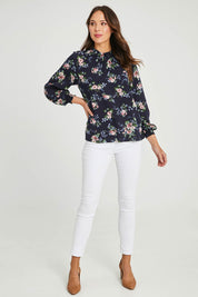 Model Madeline wearing size 10 of The Smocking Detail Printed Top in colour Flower (Blue), from the front, showing the whole outfit