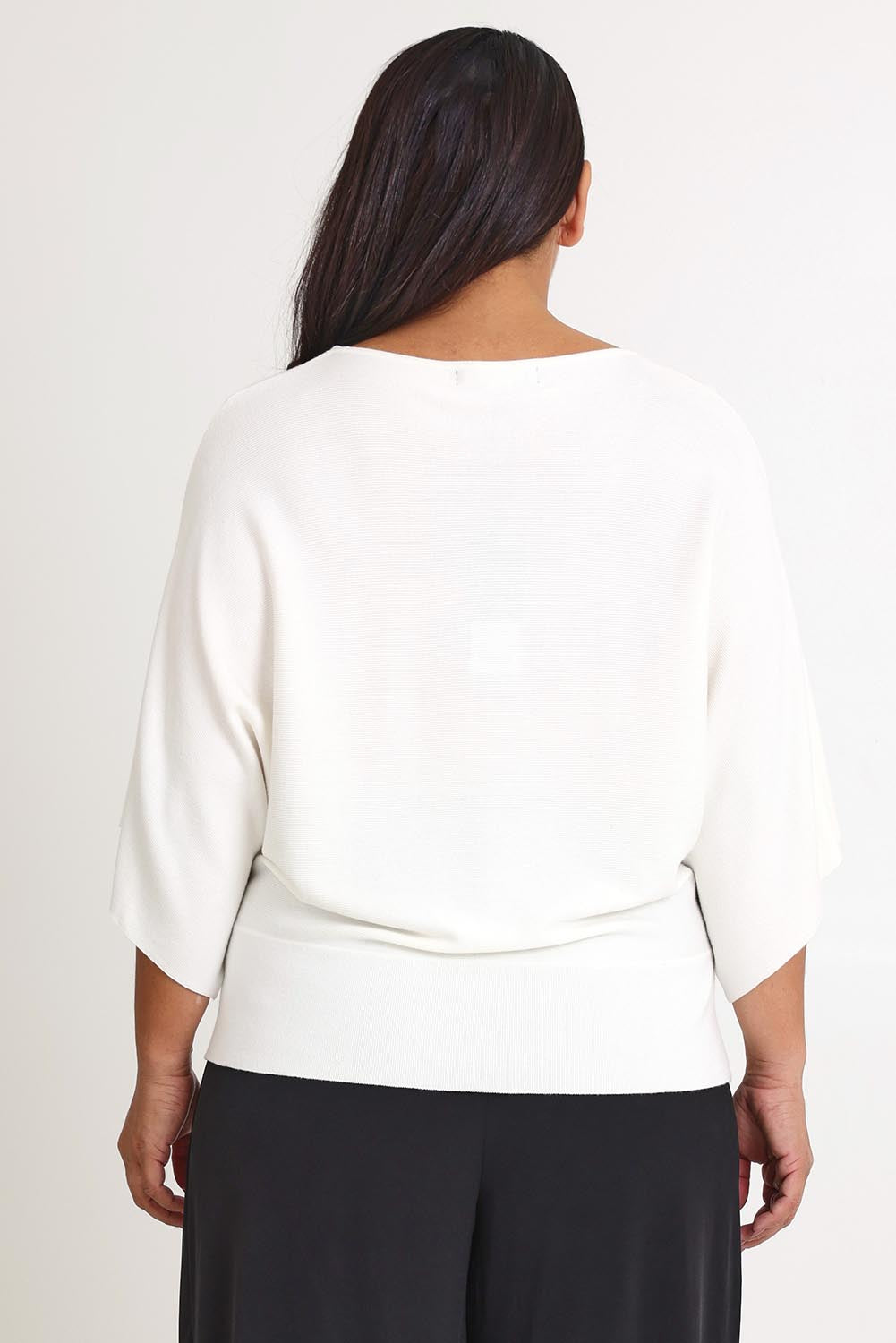Model Ashleigh wearing size XL of The Transeasonal Kimono Knit in colour Snow (White), from the back