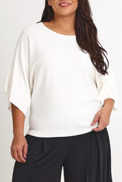 Model Ashleigh wearing size XL of The Transeasonal Kimono Knit in colour Snow (White), from the front, cropped image