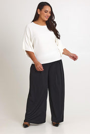 Model Ashleigh wearing size XL of The Transeasonal Kimono Knit in colour Snow (White), from the front, showing the whole outfit