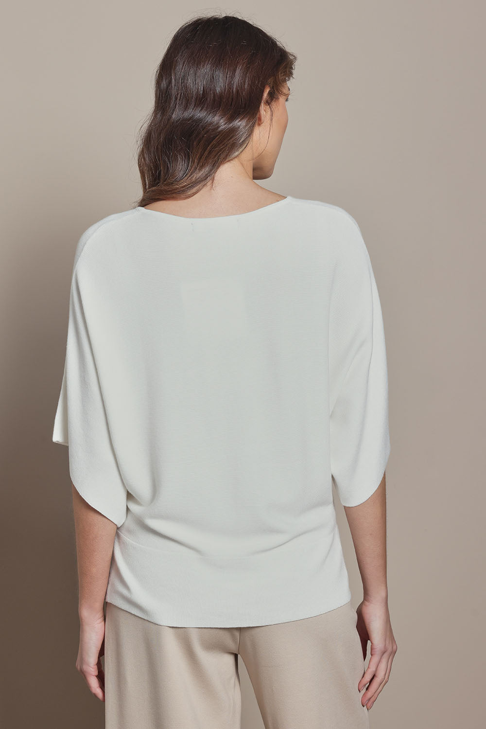 Model Madeline wearing size S of The Transeasonal Kimono Knit in colour Snow (White), from the back