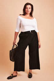 Model Poppy wearing size 16 of The Timeless Plisse Travel Pant in colour Black (Black), from the front, showing the whole outfit