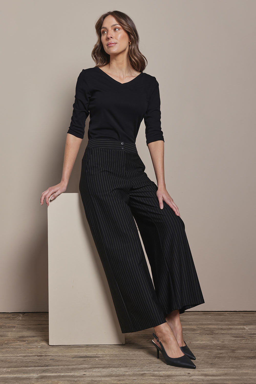 Model Madeline wearing size 10 of The Stripe Ponte Wide Leg Pant in colour Tanstripe (Black), from the front, showing the whole outfit