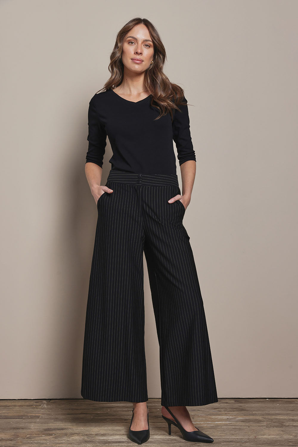 Model Madeline wearing size 10 of The Stripe Ponte Wide Leg Pant in colour Tanstripe (Black), from the front, showing the whole outfit