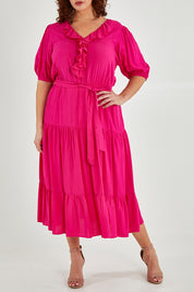 Model Maddy wearing size 16 of The Ruffle Tier Dress in colour Brightpink (Pink), from the front, cropped image