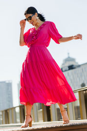 Model Miranda wearing size 10 of The Ruffle Tier Dress in colour Brightpink (Pink), from the front, showing the whole outfit