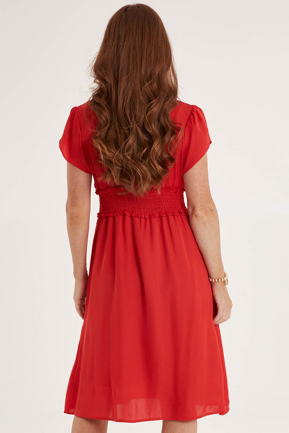 Model Sally wearing size 10 of The Luxe Tulip Sleeve Dress in colour Red (Red), from the back