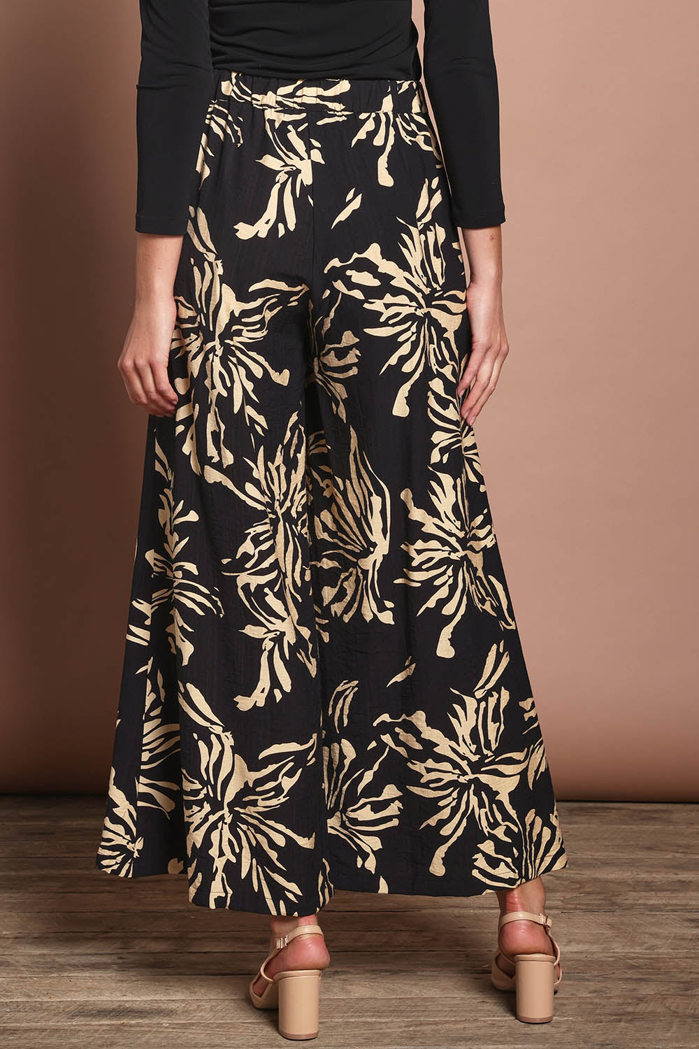 Model Madeline wearing size 10 of The Printed Flowy Panel Pull On Pant in colour Blackfleur (Black), from the back