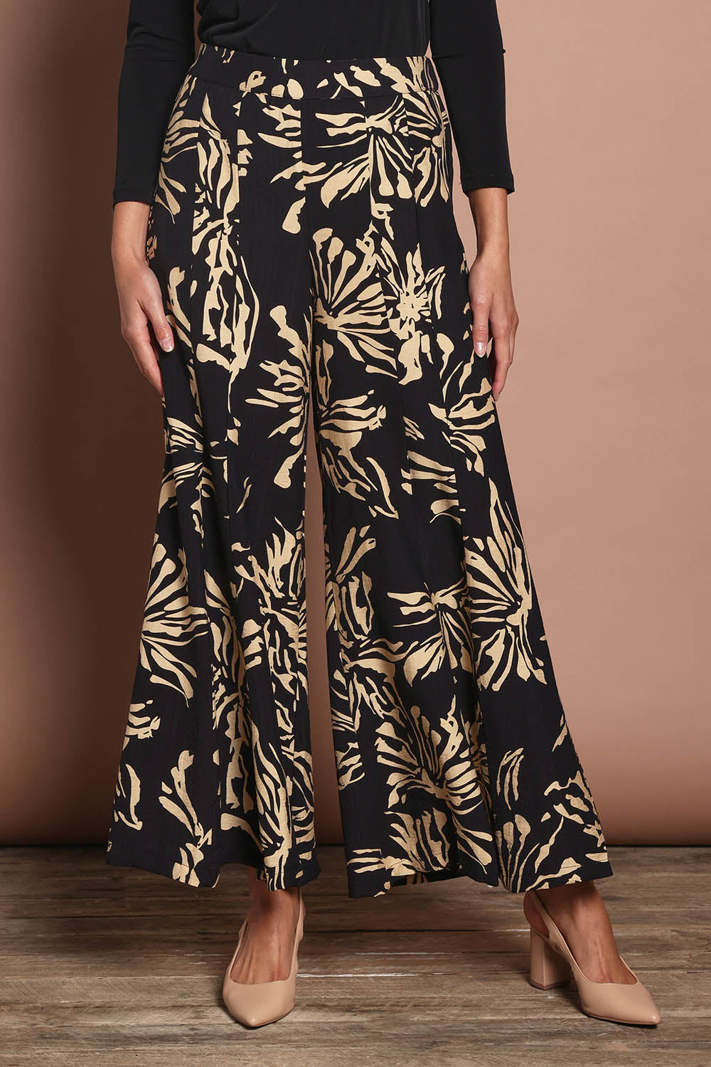 Model Madeline wearing size 10 of The Printed Flowy Panel Pull On Pant in colour Blackfleur (Black), from the front, cropped image