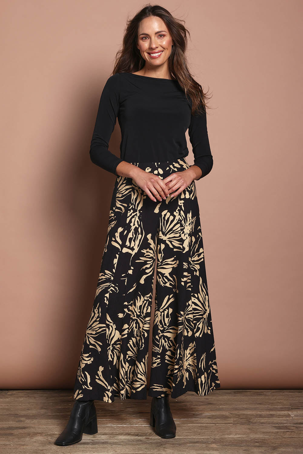 Model Madeline wearing size 10 of The Printed Flowy Panel Pull On Pant in colour Blackfleur (Black), from the front, showing the whole outfit