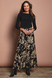 Model Madeline wearing size 10 of The Printed Flowy Panel Pull On Pant in colour Blackfleur (Black), from the front, showing the whole outfit