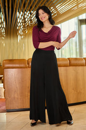 Model Miranda wearing size 10 of The Flowy Panel Pull On Pant in colour Black (Black), from the front, showing the whole outfit