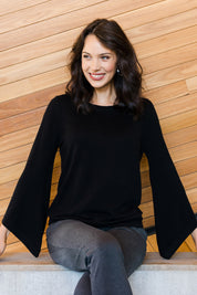 Model Andrea wearing size S of The Cotton Cashmere Angled Sleeve Knit in colour Black (Black), from the front, showing the whole outfit