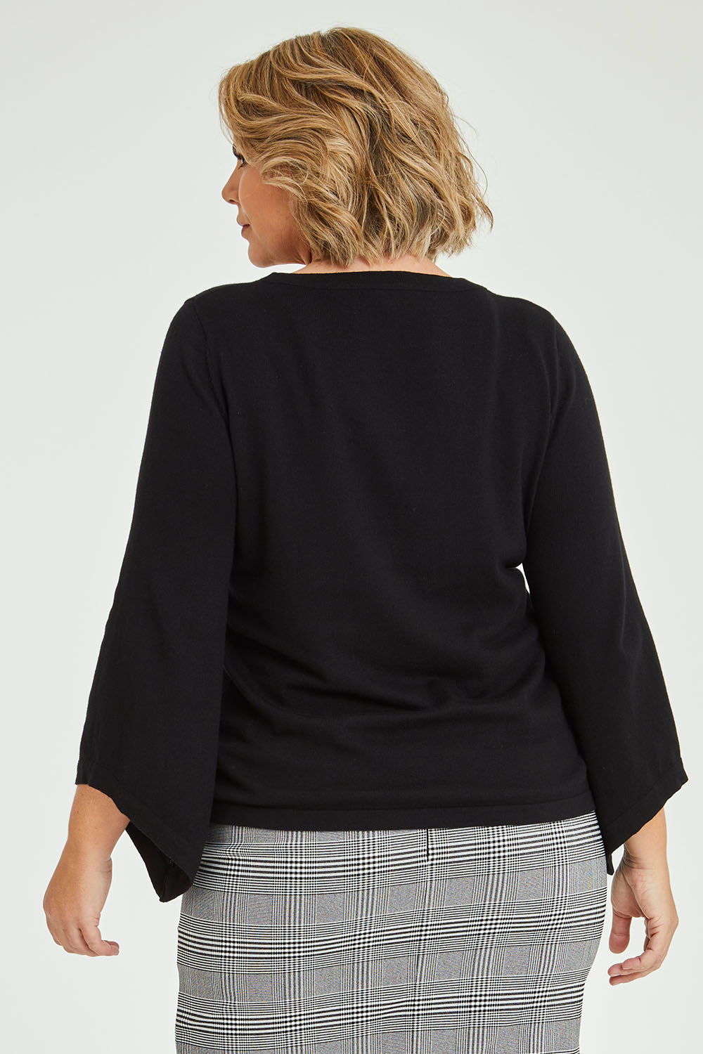 Model Fiona wearing size XL of The Cotton Cashmere Angled Sleeve Knit in colour Black (Black), from the back