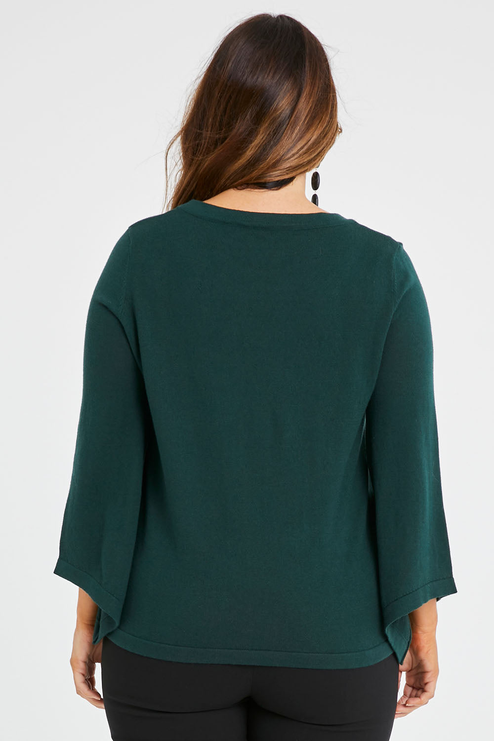 Model Laura wearing size L of The Cotton Cashmere Angled Sleeve Knit in colour Darkpine (Green), from the back