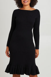Model Olivia wearing size S of The Ruffle Hem Knitted Rib Dress in colour Black (Black), from the front, cropped image