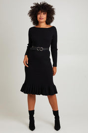 Model Olivia wearing size S of The Ruffle Hem Knitted Rib Dress in colour Black (Black), from the front, showing the whole outfit