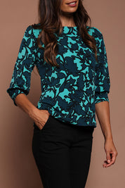 Model Amanda wearing size 10 of The Printed Boat Neck Blouse in colour Tealfleur (Green), from the front, cropped image