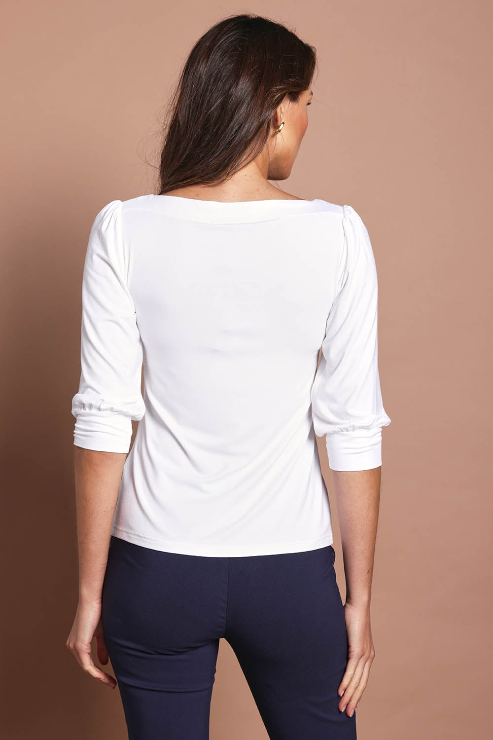 Model Madeline wearing size 10 of The Bamboo Boat Neck Top in colour Snow (White), from the back