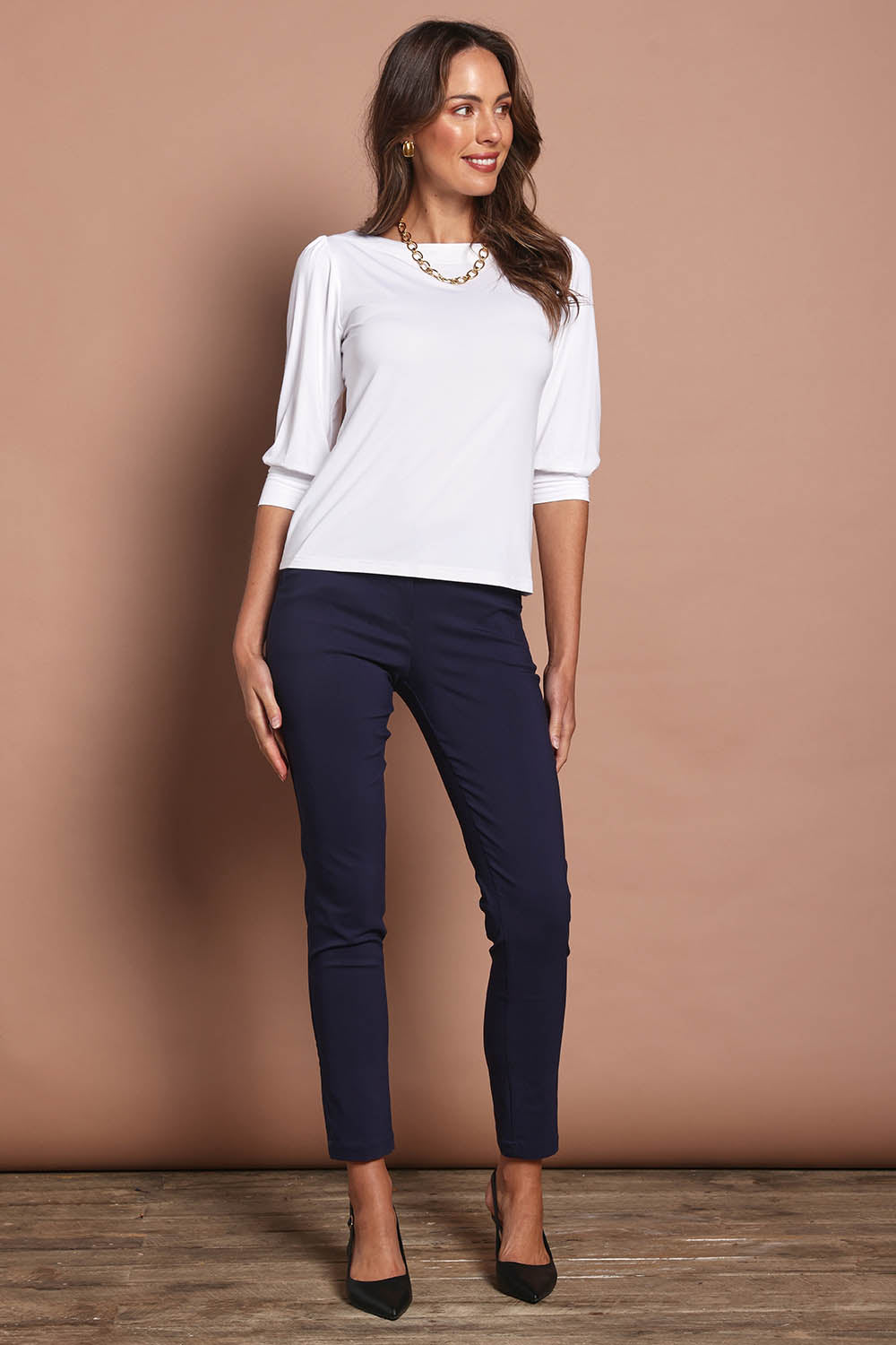 Model Madeline wearing size 10 of The Bamboo Boat Neck Top in colour Snow (White), from the front, showing the whole outfit