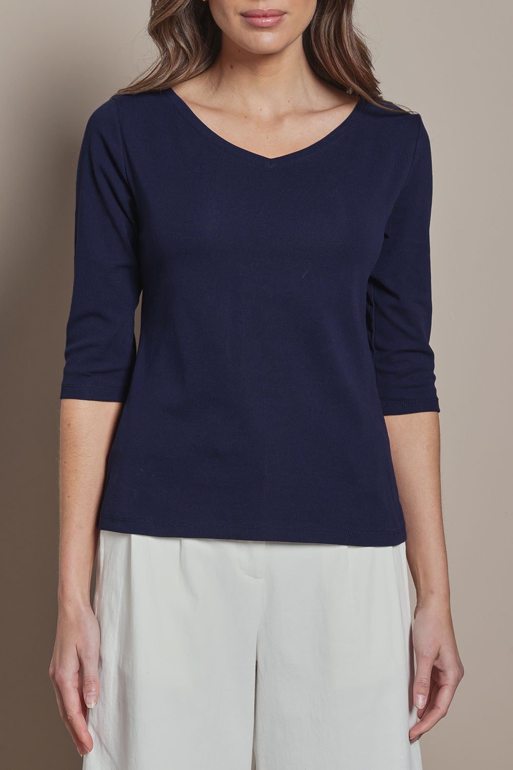 Model Madeline wearing size 10 of The Reversible Cotton Stretch Top in colour Navy (Blue), from the front, cropped image