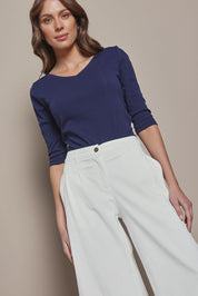 Model Madeline wearing size 10 of The Reversible Cotton Stretch Top in colour Navy (Blue), from the front, cropped image
