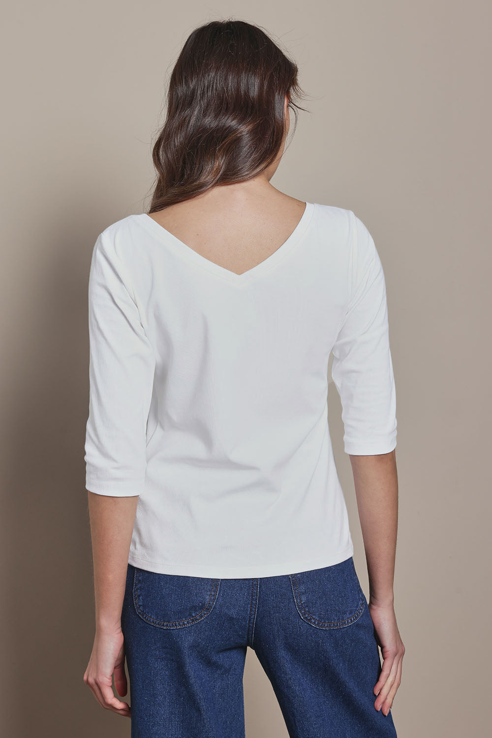 Model Madeline wearing size 10 of The Reversible Cotton Stretch Top in colour White (White), from the back