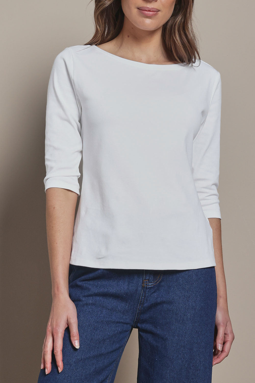 Model Madeline wearing size 10 of The Reversible Cotton Stretch Top in colour White (White), from the front, cropped image