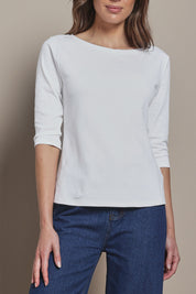 Model Madeline wearing size 10 of The Reversible Cotton Stretch Top in colour White (White), from the front, cropped image
